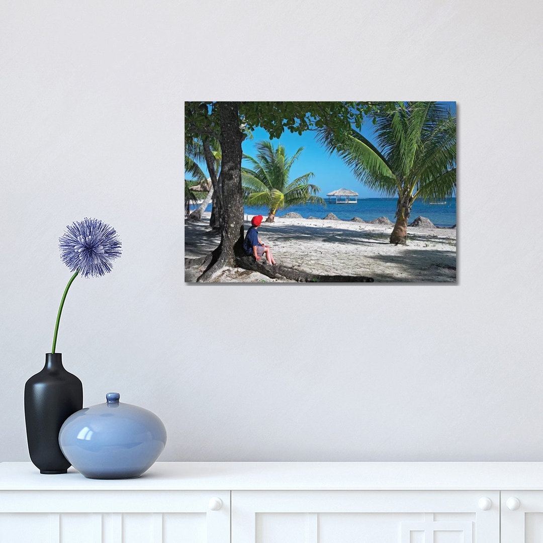 Tourist Resting Under Palm Trees On Beach At Palmetto Bay, Roatan Island, Honduras