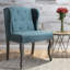 Fauteuil à oreilles classique bleu sarcelle avec boutons et clous capitonnés