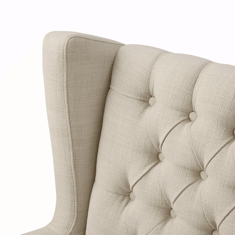 Fauteuil à oreilles capitonné