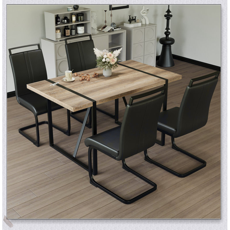 Table de salle à manger moderne moderne en bois aggloméré avec pieds en métal noir et chaises en polyuréthane sans accoudoirs, parfaite pour les cuisines et les salles à manger contemporaines.