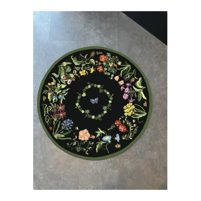 Tapis rond noir à motif tissé à base botanique