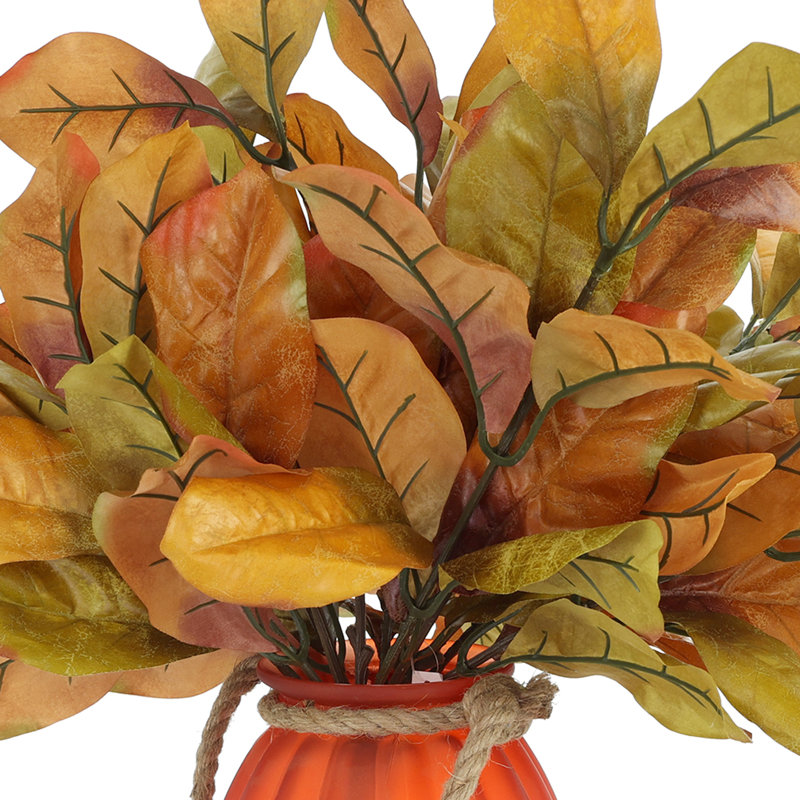 Fall Leaves Arranged in Glass Pumpkin Vase