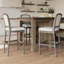 Tabouret de bar gris patiné avec assise et dossier rembourrés gris