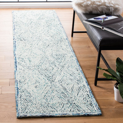 Tapis géométrique bleu / ivoire en laine touffetée à la main de la personne