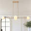 Lustre linéaire chic en laiton à 4 lampes en verre globe