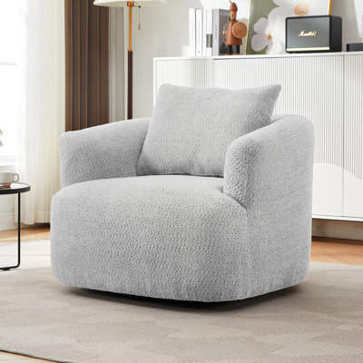 Fauteuil pivotant rembourré en tonneau avec coussin décoratif