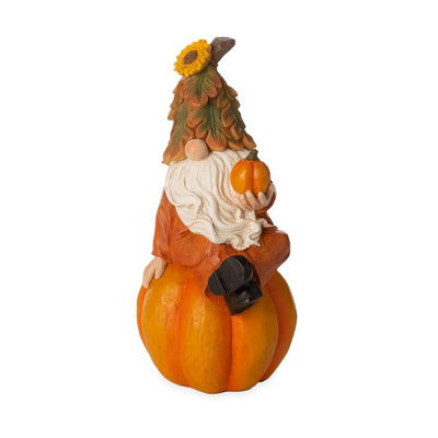 Gnome heureux sur citrouille