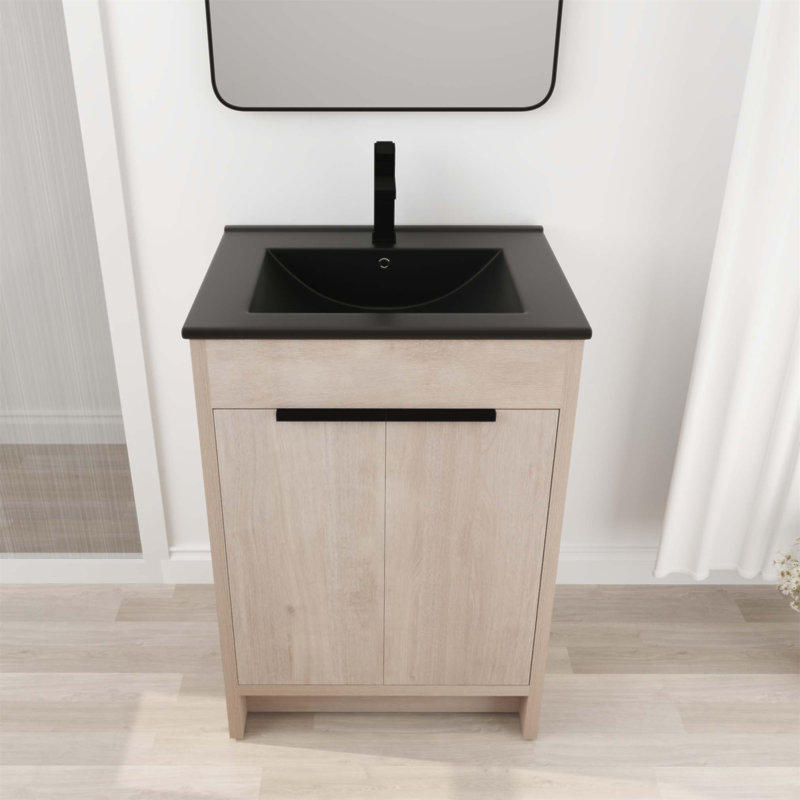 Meuble-lavabo autoportant de 24 pouces avec lavabo en céramique et deux portes d'armoire à fermeture en douceur, parfait pour les espaces modernes et compacts.