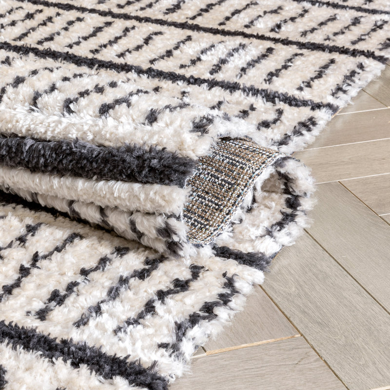 Ivory and Black Geometric Synthetic 4' x 6' Area Rug