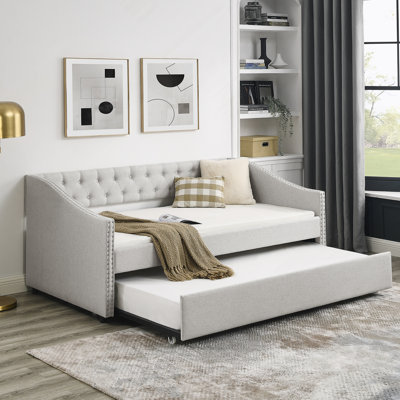 Lit de jour avec couchette rembourrée et capitonnée, avec bouton à l'arrière