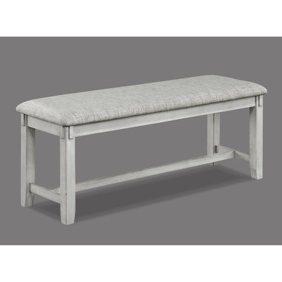 Banc contemporain en bois flotté avec assise rembourrée grise et pieds fuselés pour manger en bois massif dans l'espace