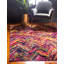 Tapis rose / mauve / rouge à motif de chevrons Shirey-1699811391