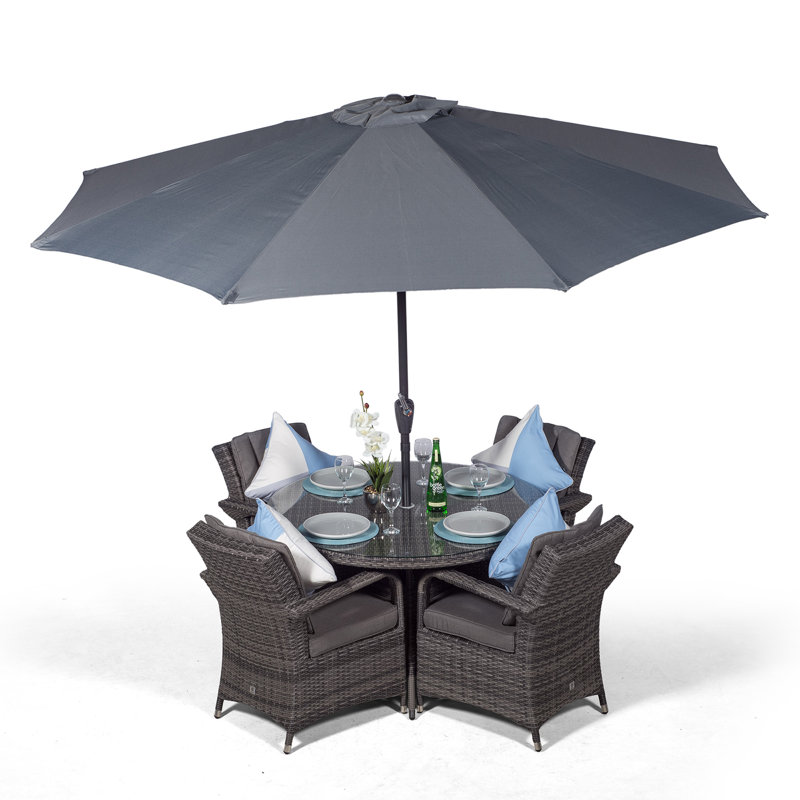 Karas 4 - Person Wicker Patio Dining Set with Round Table , Cushions Included