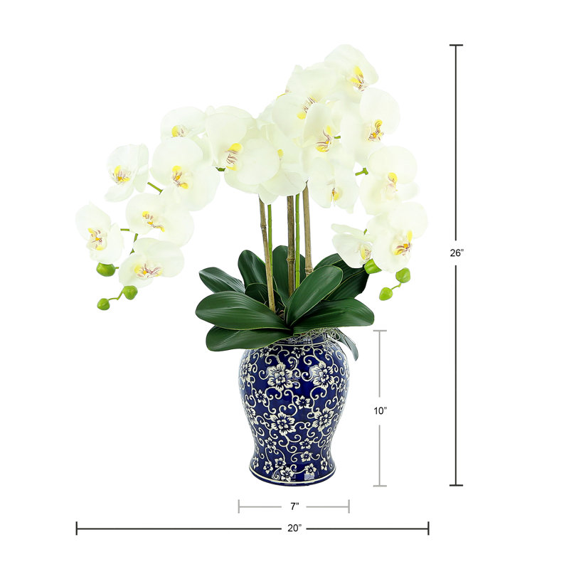 Orchid Arrangement In A Ceramic Vase With Leaves