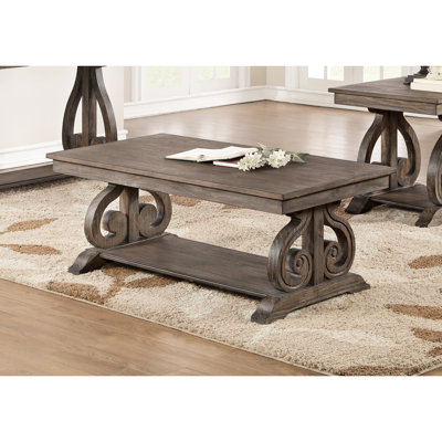 Table basse classique en chêne foncé avec base élégante à volutes et support traditionnel