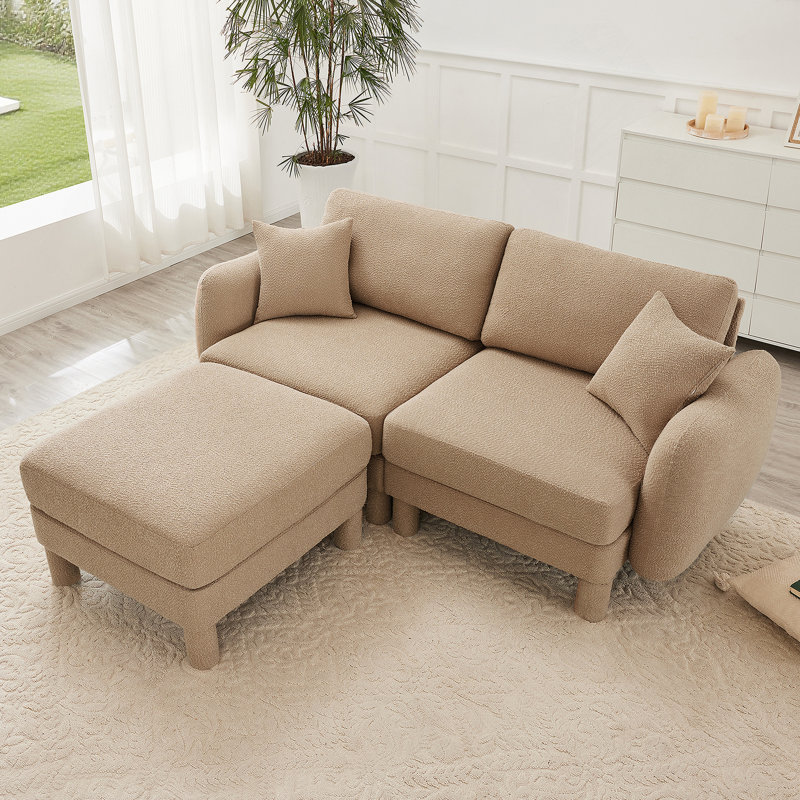 Canapé-lit à 2 places en tissu Boucle avec accoudoirs en forme de coquillage distinctif, repose-pieds amovible et pieds cylindriques pour une assise confortable