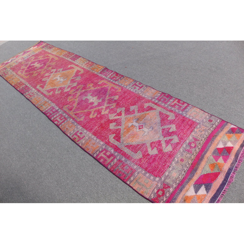 Faites l'expérience d'une touche d'élégance rétro dans votre salon avec ce tapis turc en laine rose