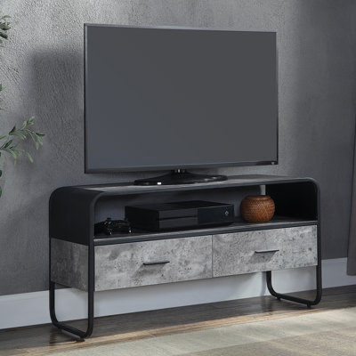 Meuble télé moderne en béton gris et noir avec base stable, pouvant accueillir des téléviseurs noirs de 40 à 49 pouces, offrant une solution pour votre