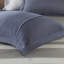 Twin Bedroom With Blue Grey Striped Sheets And Comforter & Round Pillow