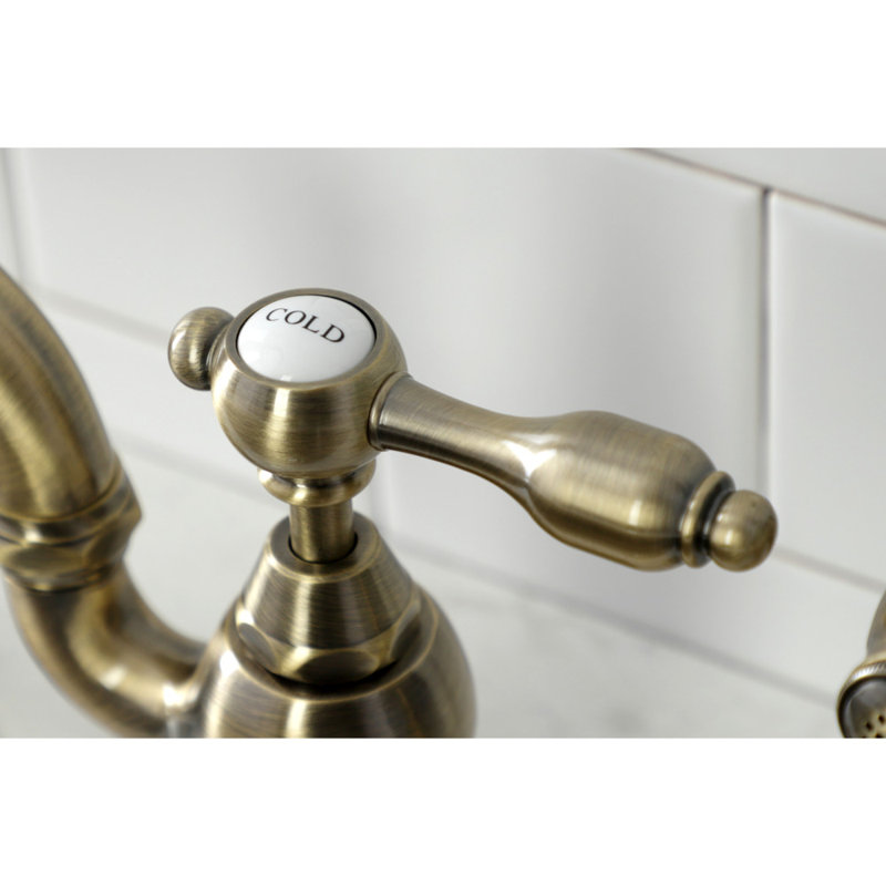 Kingston Brass Tudor Two-Handle 3-Hole Deck Mount Bridge Kitchen Faucet with Brass Side Sprayer, Antique Brass