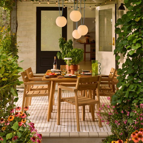 Outdoor dining table with hanging pendant lights.
