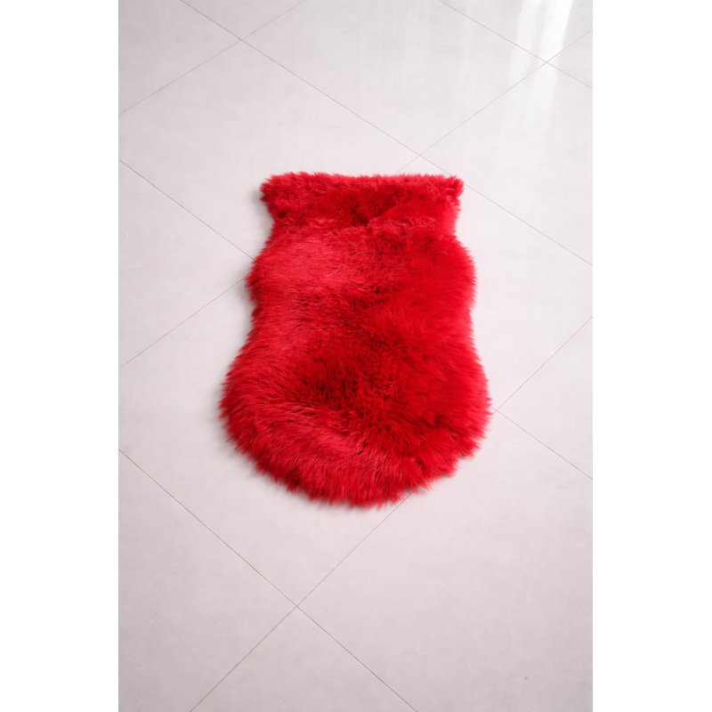 Oval Solid Colour Sheepskin 60cm X 110cm Area Rug, Red