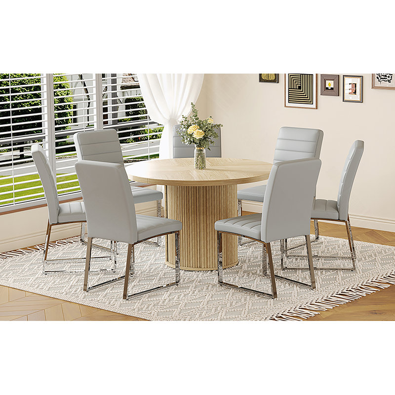 Ensemble de deux chaises rembourrées en polyuréthane avec table ronde et rangement, idéales pour les restaurants et offrant une expérience de repas confortable