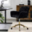 Chaise de bureau réglable - Noire, avec base en métal doré et siège rembourré en mousse.