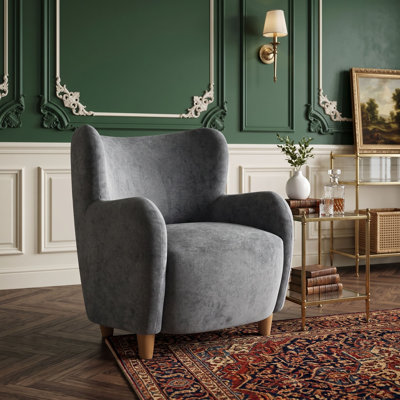 Fauteuil à oreilles en velours avec coussin à ressorts ensachés et pieds en bois massif
