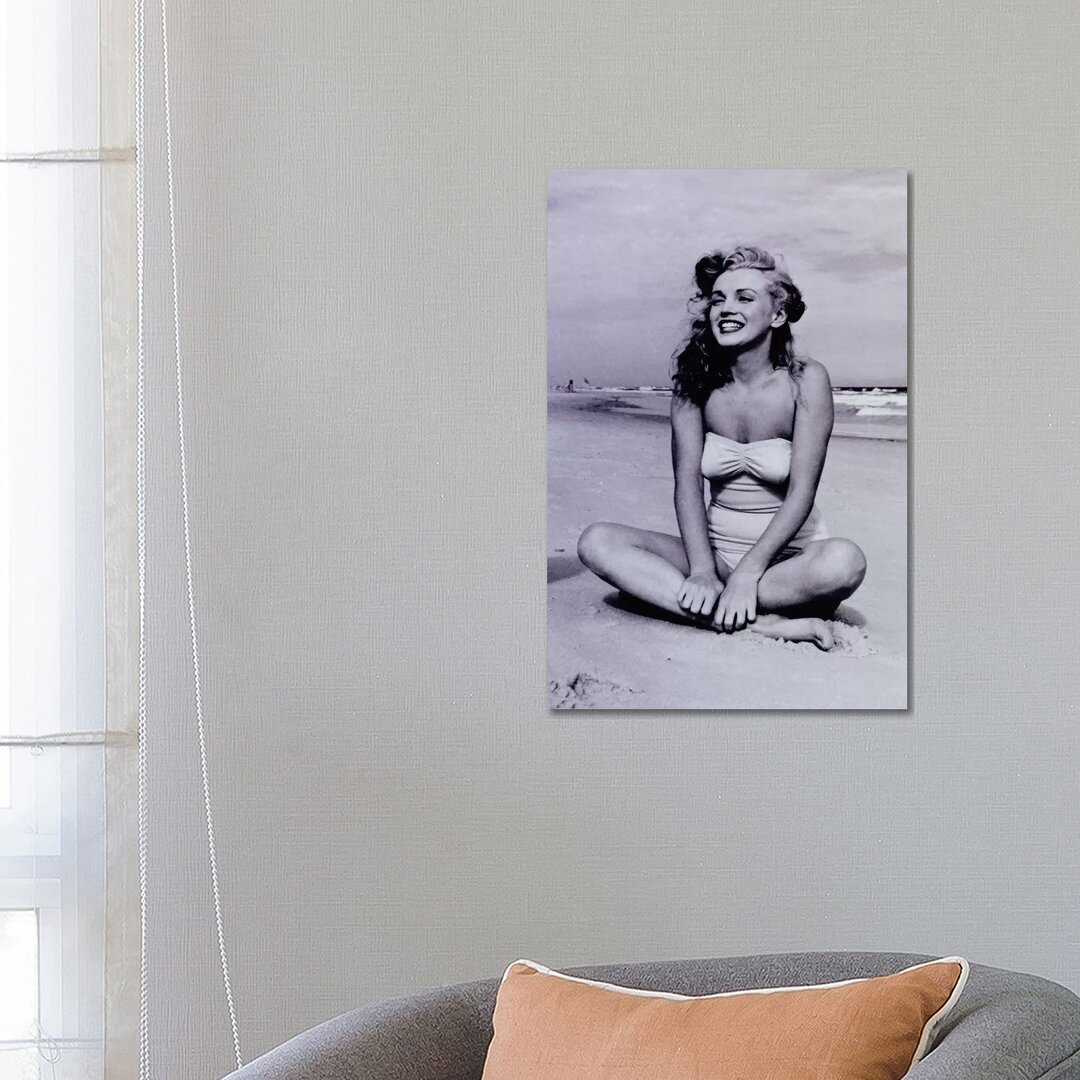 Leinwandbild A Young, Smiling Marilyn Monroe Sitting on the Beach von Radio Days