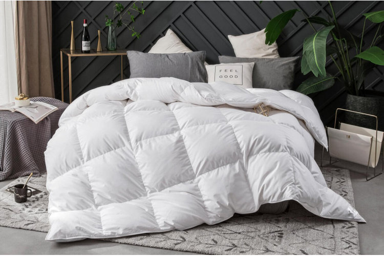 white down comforter with a plush, high-loft design on a modern bed with layered pillows