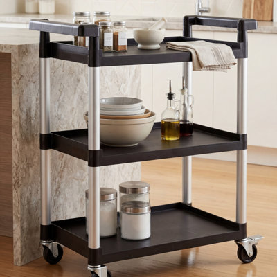 This Black Three-Layer Plastic Mobile Storage Cart Features Wheels And A Total Load Capacity Of Up To 225 Pounds. It Is Practical, Sturdy, And Made Of Black Plastic.