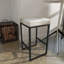 Tabouret de comptoir en cuir de vache beige Ursae avec base en métal noir