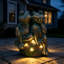Sculpture fantaisiste représentant un couple de grenouilles enlacées, avec éclairage solaire d'ambiance, en oxyde de magnésium à patine bronze, décoration extérieure pour terrasse et jardin.