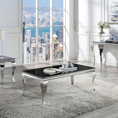 Table basse contemporaine avec plateau en verre et pieds en acier inoxydable