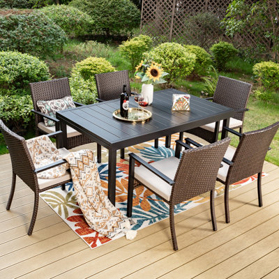 Argyri Rectangular 7-pieces Patio Dining Set Extendable Metal Table And Rattan Armchairs With Cushions by Lark Manor