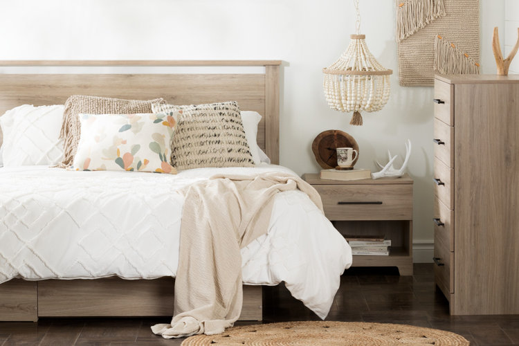 bohemian bedroom with small beaded empire chandelier hanging above nightstand