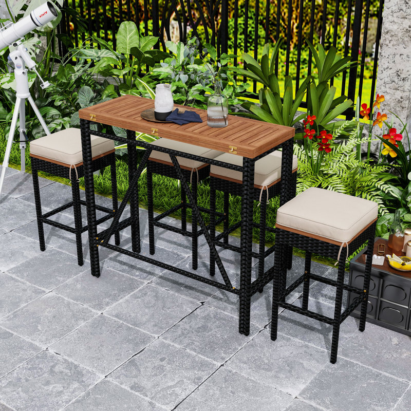 Ensemble repas d'extérieur 5 pièces avec table pliable en bois d'acacia, tabourets en osier et coussins pour la cour