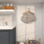 Décoration murale grise en métal avec cintre en bois brun