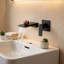 Robinet de lavabo mural noir mat avec bec cascade et valve brute en laiton