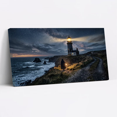 Tableau sur toile d'Halloween représentant un phare et une silhouette encapuchonnée sous un ciel étoilé