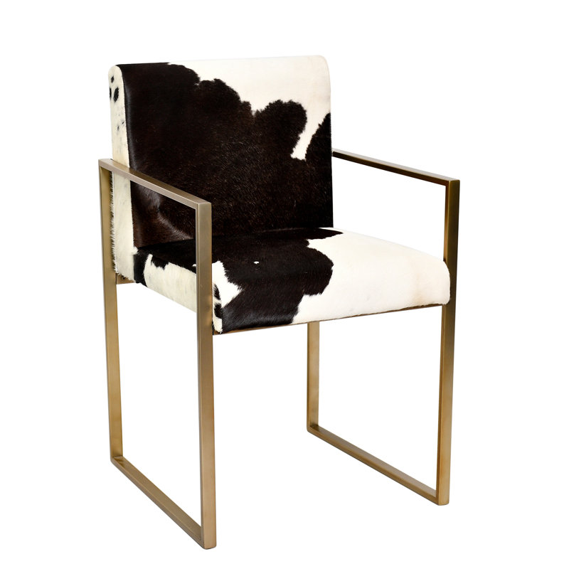 A GOLD STAINLESS STEEL CHAIR WITH BLACK & WHITE COW LEATHER