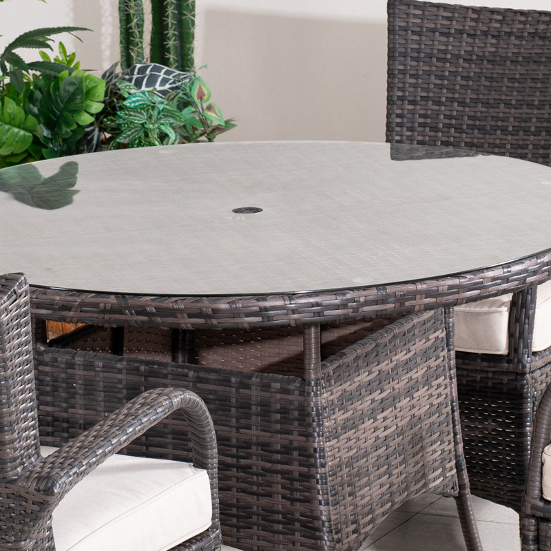Omied 4 - Person Wicker Patio Dining Set with Round Table , Cushions Included