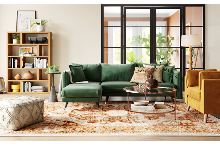 modern living room with green sofa, yellow armchair, and a rose gold coffee table