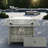 Propane Gas Fire Pit Table With Glass Wind Guard And An Open Basket-wave Patterned Wicker-947424578
