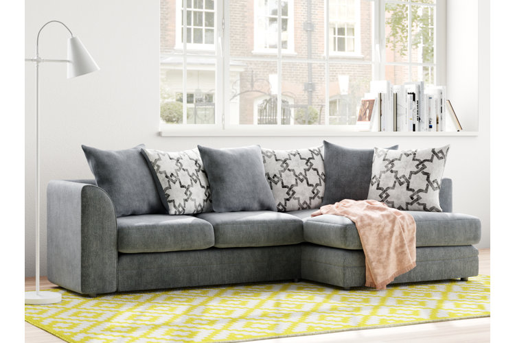casual gray sofa with a chaise and geometric throw pillows in a modern living room