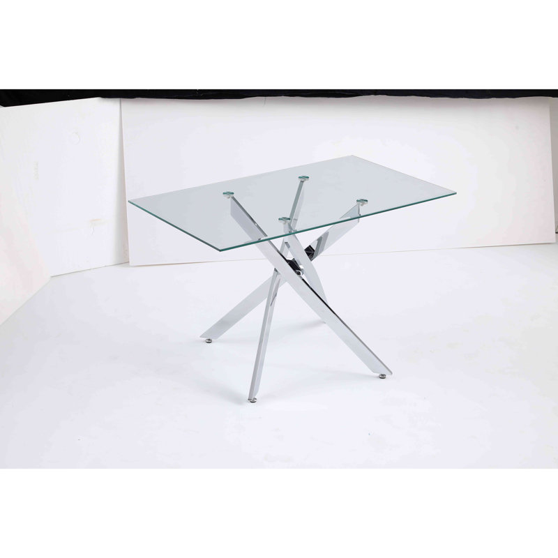 Le plateau de table rectangulaire moderne en verre trempé est jumelé à un cadre en fer