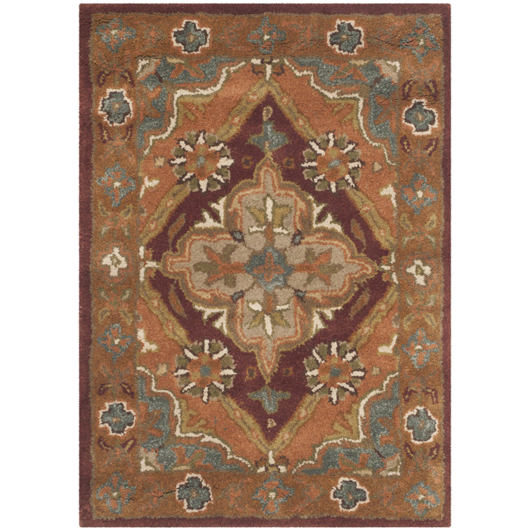 Ezell Hand Tufted Wool/Cotton/Latex Floral Rug in Rust