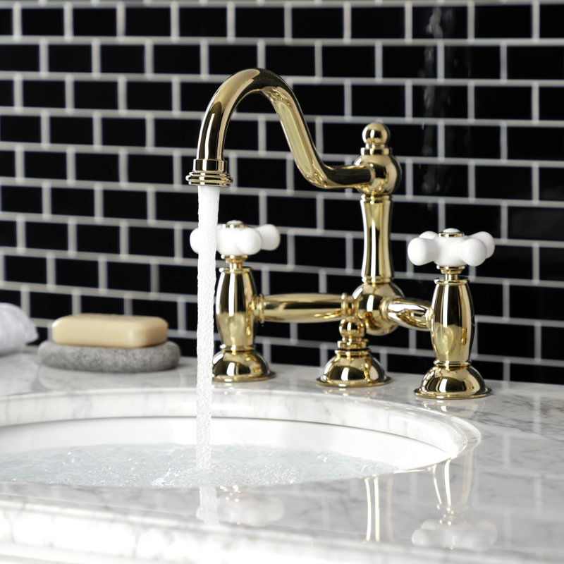 Kingston Brass Restoration Two-Handle 3-Hole Deck Mount Bridge Bathroom Faucet with Brass Pop-Up, Polished Brass