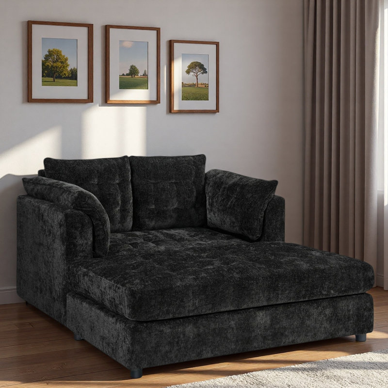 Chaise longue moderne avec accoudoirs moelleux, assise profonde capitonnée et dossier confortable., Noir